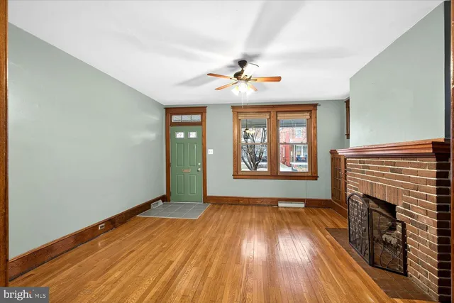 wooden floor in an empty room with a window