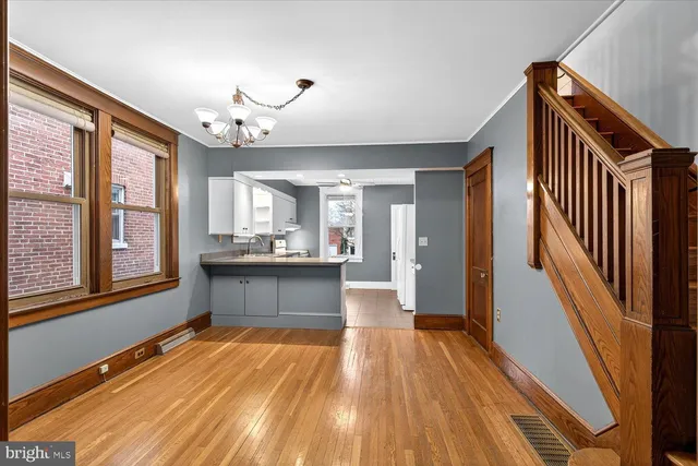 a view of a living room and kitchen with wooden floor
