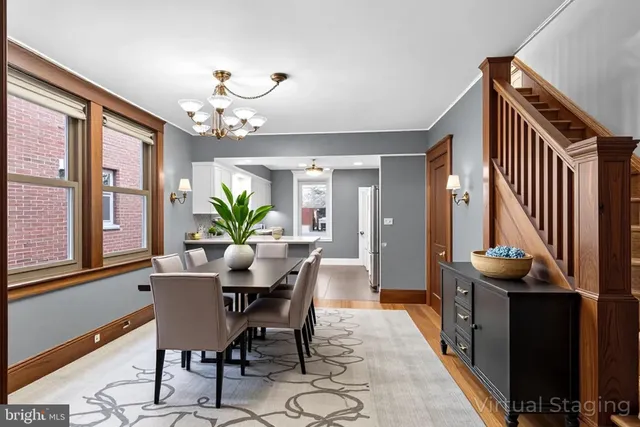 a view of a dining room with furniture and a chandelier