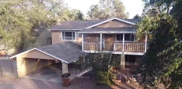 a front view of a house with yard garage and outdoor seating