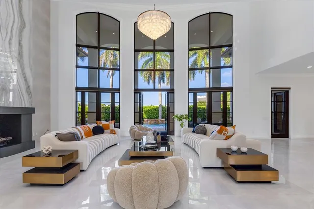 a view of a dining room and kitchen with furniture wooden floor and a chandelier