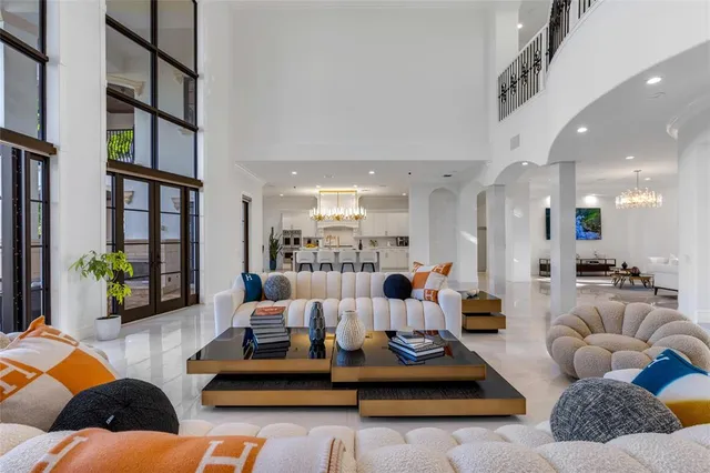 a spacious bedroom with a bed and a chandelier