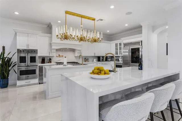 a bedroom with a large bed and a chandelier