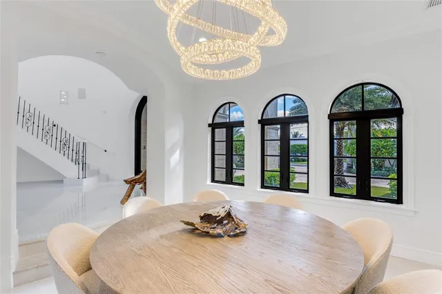 a spacious bedroom with bed and a chandelier