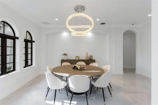 a bedroom with a large bed and windows