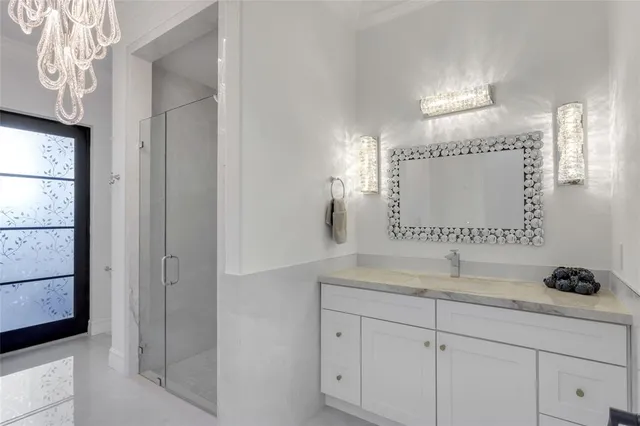a bathroom with a granite countertop toilet a sink and mirror