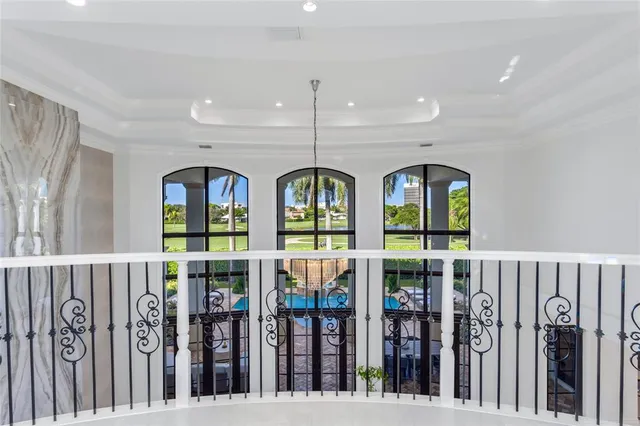 a view of a patio with couple of chairs and a potted plant