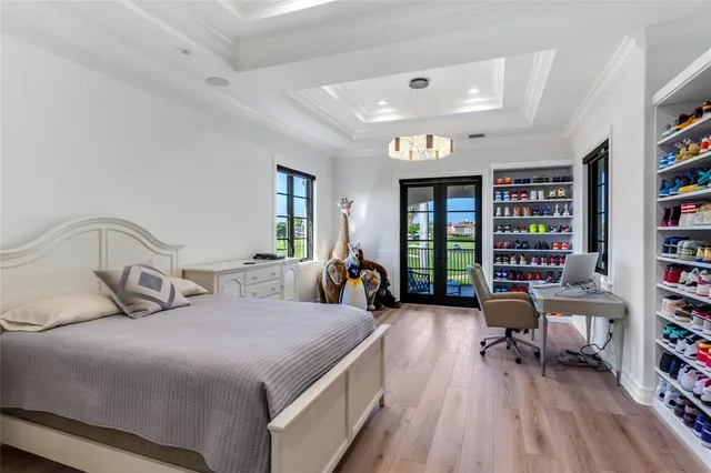 a view of swimming pool with a table and chairs potted plants