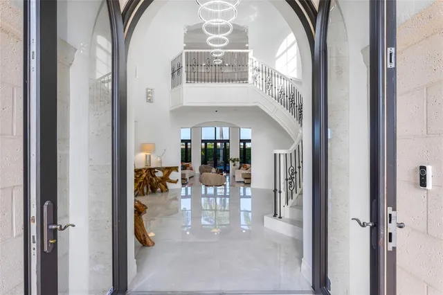 a living room with furniture kitchen view and a large window