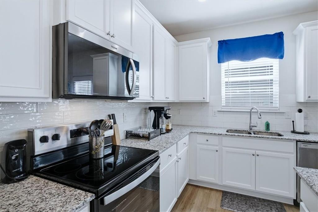 3980 Riverchess Drive Southwest Atlanta, GA 30331 - Photo 13 of 46 a kitchen with stainless steel appliances a sink stove and cabinets