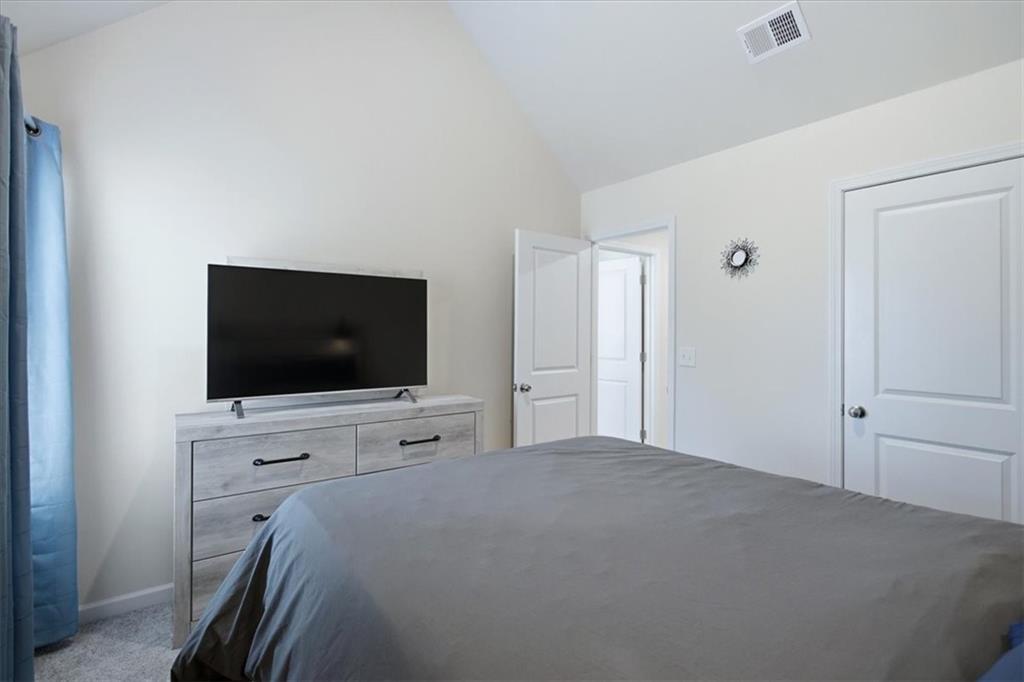 3980 Riverchess Drive Southwest Atlanta, GA 30331 - Photo 17 of 46 a bedroom with a bed and a flat screen tv