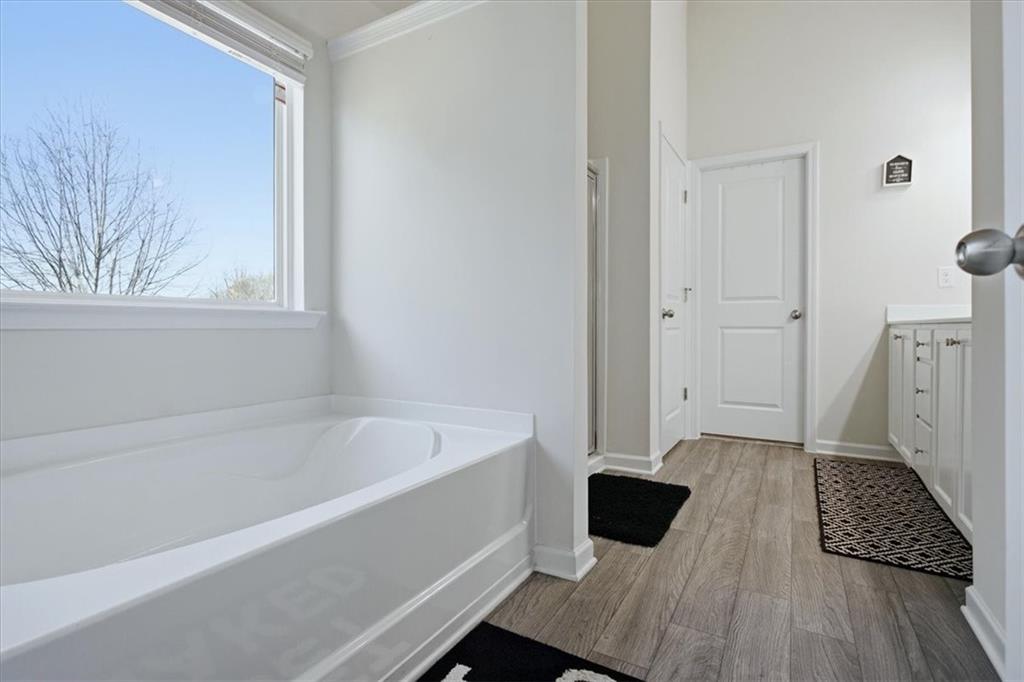 3980 Riverchess Drive Southwest Atlanta, GA 30331 - Photo 25 of 46 a bathroom with a bathtub and a window