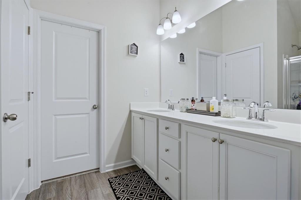 3980 Riverchess Drive Southwest Atlanta, GA 30331 - Photo 27 of 46 a bathroom with a double vanity sink a mirror and a vanity
