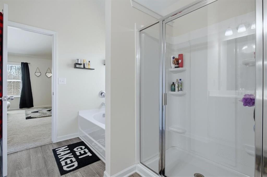 3980 Riverchess Drive Southwest Atlanta, GA 30331 - Photo 28 of 46 a bathroom with a bathtub and a shower