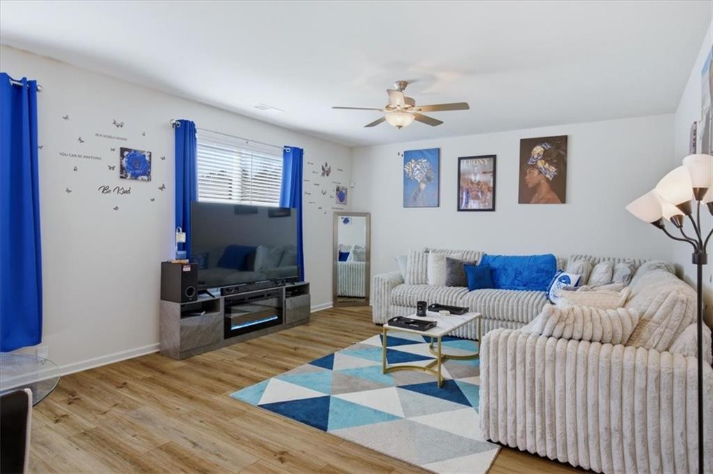 3980 Riverchess Drive Southwest Atlanta, GA 30331 - Photo 8 of 46 a living room with furniture and a flat screen tv
