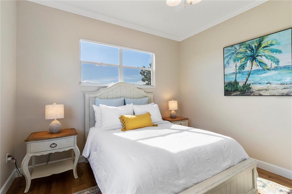 7325 Holly Road Terra Ceia, FL 34250 - Photo 43 of 87 a bedroom with a bed and wooden floor