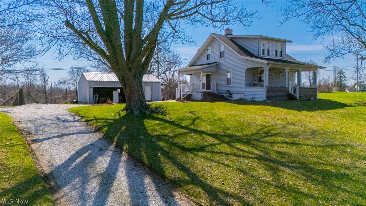 53341 Key Bellaire Road Bellaire, OH 43906 - Photo 2 of 48 View of front of home with an outdoor structure, covered porch, a front lawn, a chimney, and driveway