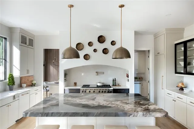 an entryway with wooden floor and cabinet