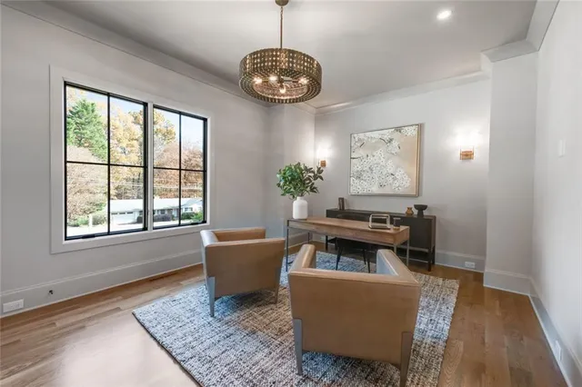 a bathroom with a sink a toilet a mirror and shower