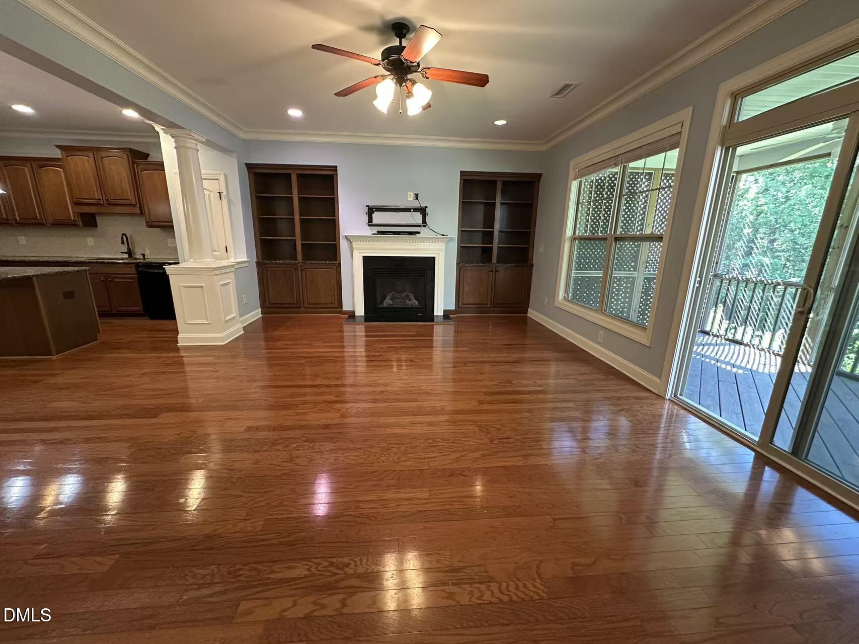 1056 Indigo Ridge Place Cary, NC 27519 - Photo 10 of 33 a view of a living room a kitchen with furniture a fireplace and wooden floor
