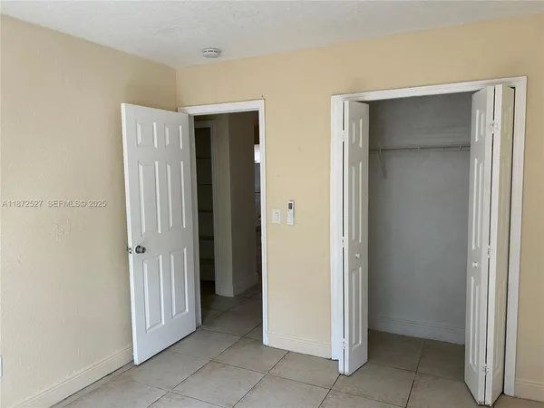 a view of a hallway with closet area