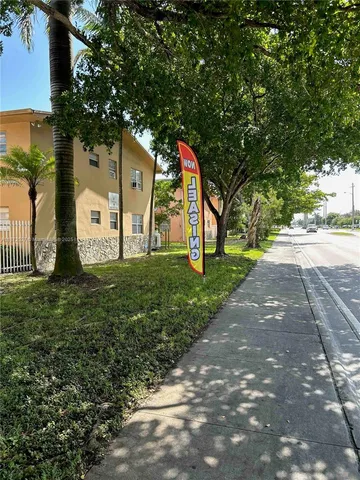 a view of a park with large trees