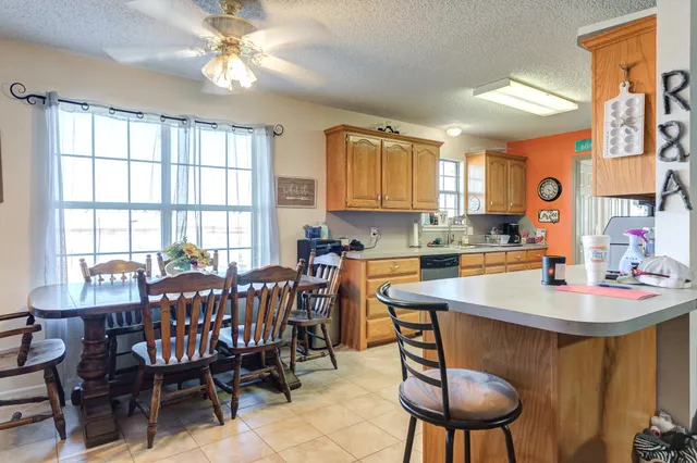 a view of a dining room with furniture and a chandelier