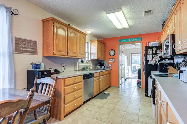 a kitchen with stainless steel appliances granite countertop a sink and cabinets