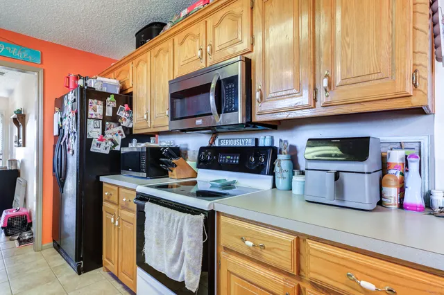 a kitchen with stainless steel appliances granite countertop a stove and a microwave