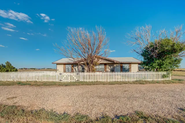 a view of a house with a fence