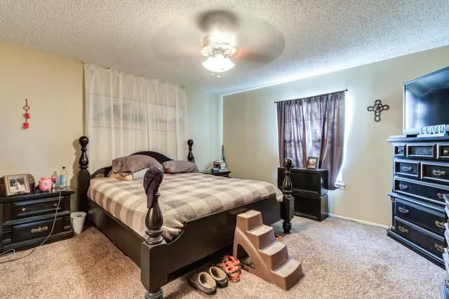 a bedroom with a bed and a chandelier