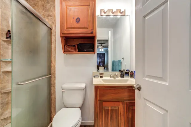 a bathroom with a toilet sink and mirror