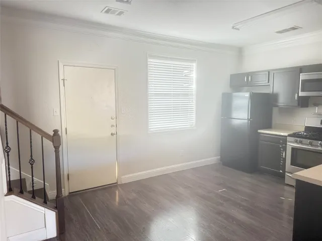 an empty room with wooden floor and a window