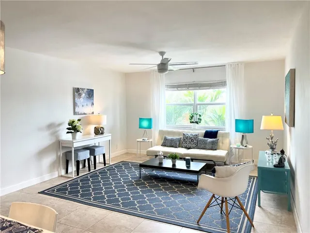 a living room with furniture rug and window