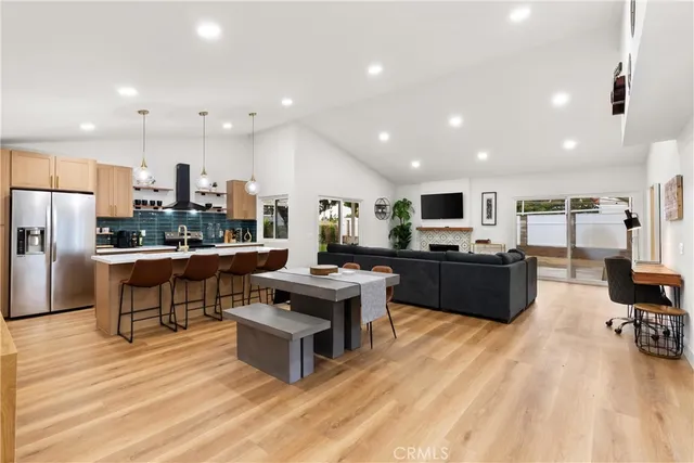 a kitchen with stainless steel appliances kitchen island granite countertop a refrigerator and a stove top oven