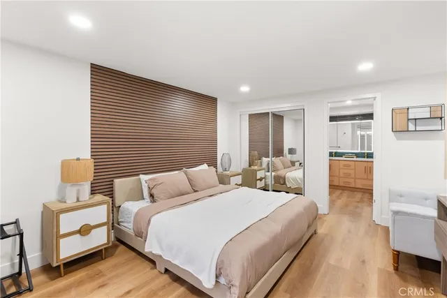 a bedroom with a bed and a view of kitchen