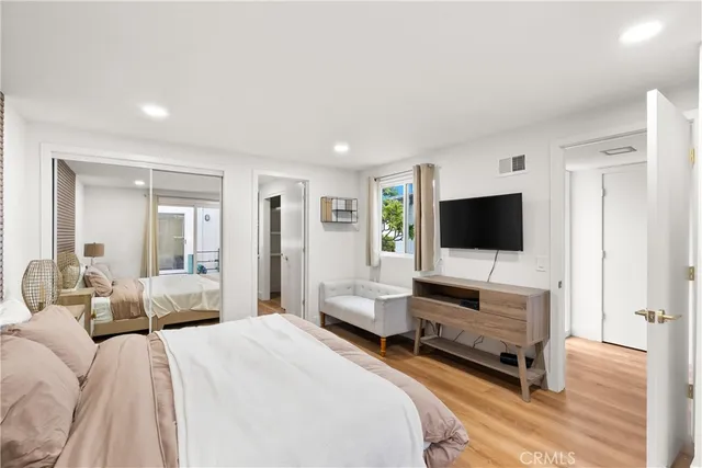 a bedroom with a bed and a flat screen tv