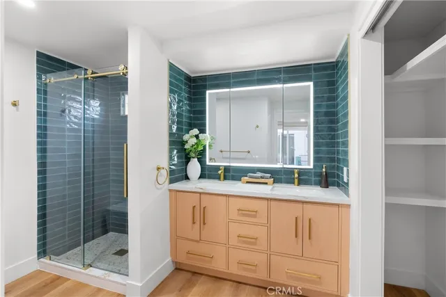 a bathroom with a granite countertop sink mirror and shower
