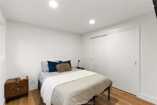 a bedroom with a bed and a tv