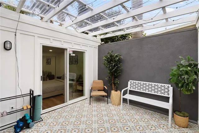 a view of a porch with a bench and a potted plant