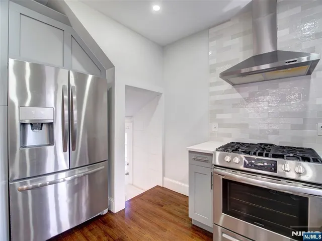 a kitchen with a stove and a refrigerator