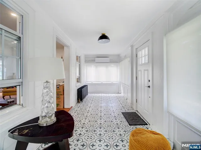 a bathroom with a tub sink and mirror