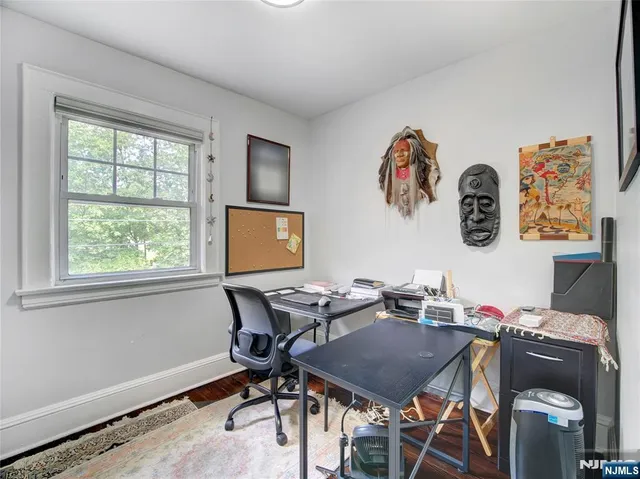 a view of a workspace with furniture and a window
