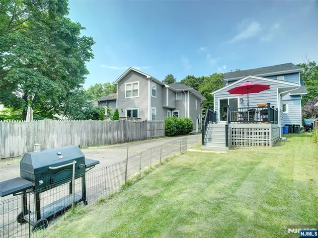 a view of a house with a yard and sitting area
