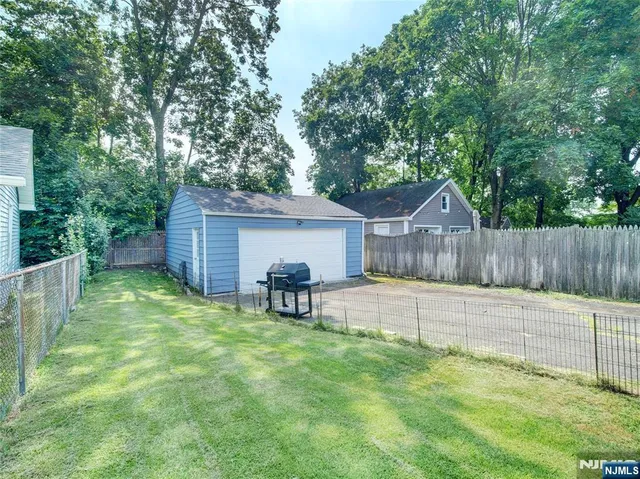 a view of a house with a yard and sitting area
