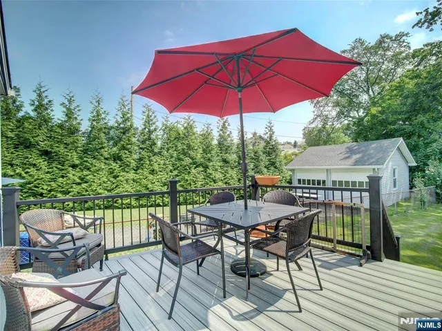 a view of a patio with furniture and a garden