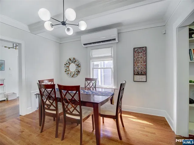 a view of a dining room with furniture and chandelier