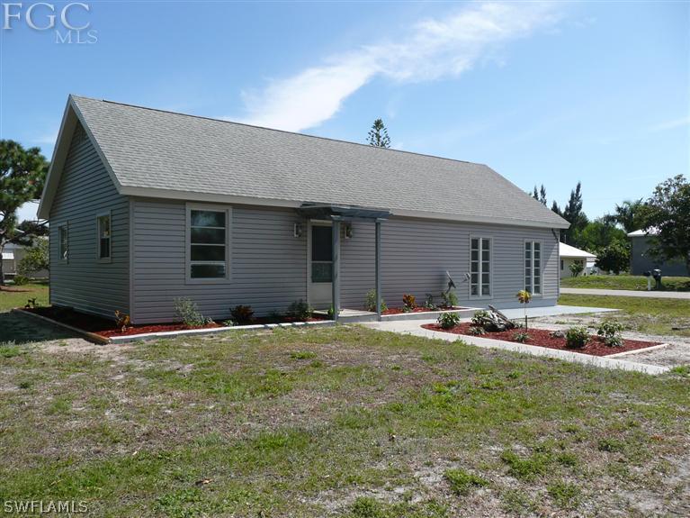 5952 Sailfish Road Bokeelia, FL 33922 - Photo 1 of 20 a backyard of a house with table and chairs