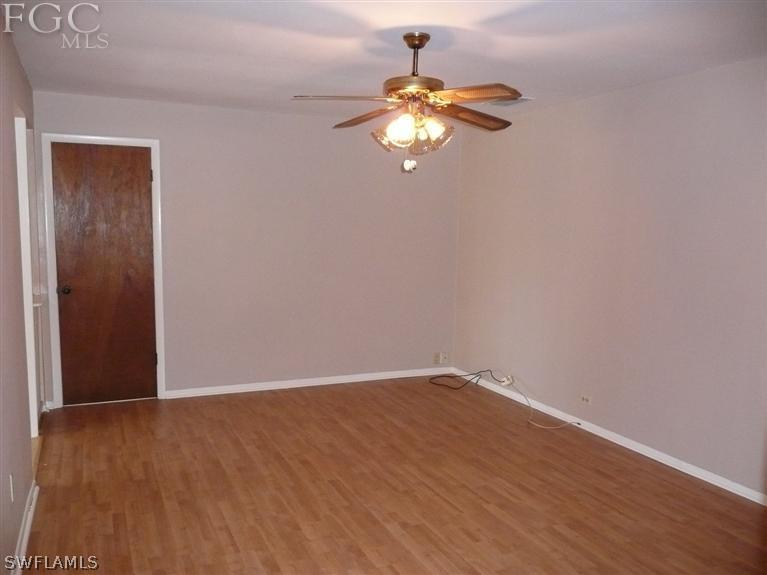 5952 Sailfish Road Bokeelia, FL 33922 - Photo 15 of 20 a view of a small space with wooden floor and chandelier