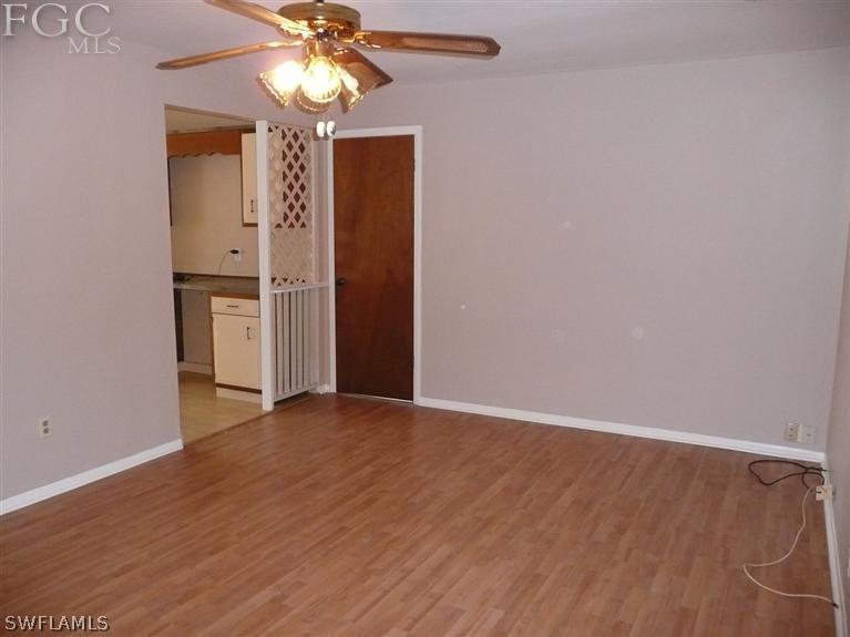 5952 Sailfish Road Bokeelia, FL 33922 - Photo 16 of 20 a view of an empty room with window and wooden floor